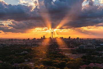 Fototapeta premium Cityscape at sunset Sun rays over tall buildings and trees below; tourism