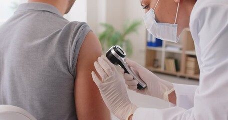 Doctor screen arm with tool testing procedure to diagnose melanoma, physical exam, healthcare professional checking health, skin cancer study, dermatologist specialist helping with cosmetic problems