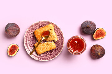 Jar of sweet fig jam and plate with tasty toast on lilac background