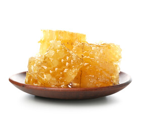 Plate with sweet honeycombs on white background