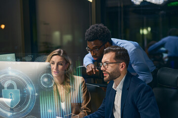 Collaborative teamwork discussing cybersecurity concepts with a futuristic digital interface.