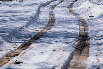 Tire marks on snowy dirt road