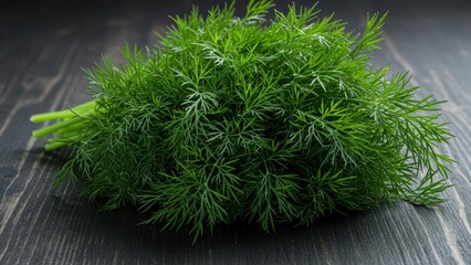 Fototapeta premium Fresh dill on wooden surface, commonly used as culinary herb for seasoning Themes: healthy eating, sustainability