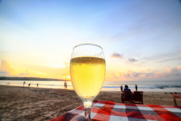 a glass of white wine on the background of the sea relaxing by the sea with wine