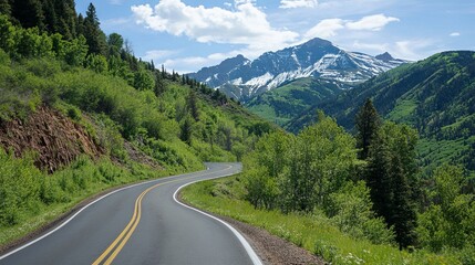 Fototapeta premium Winding mountain road surrounded by lush greenery