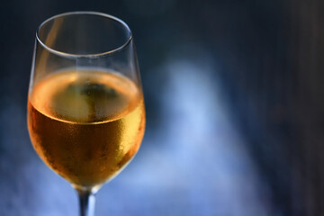 A glass of white wine on a blurred abstract background, alcohol, relaxation