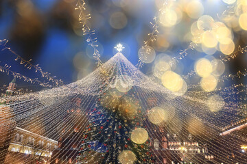 Fototapeta premium outdoor Christmas decorations with lights and garlands at night in Moscow