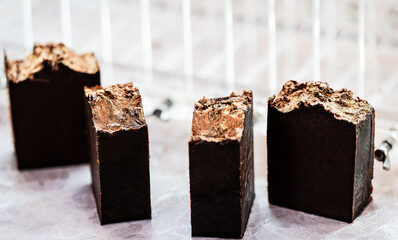 Close-up of handmade dark brown soap bars.