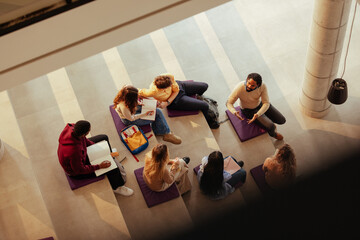University students studying and discussing on building steps