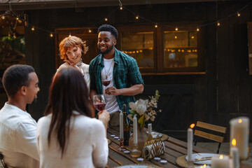 Couple standing next to a table and proposing a toast to their friends