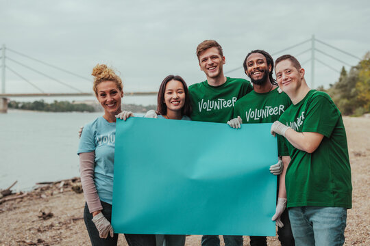 Volunteers holding blank placard by the river - Powered by Adobe