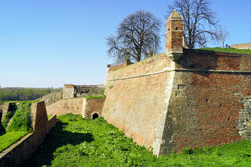 Landscape from Belgrade Fortress: defensive brick walls with an arched passage and a corner watchtower. The architecture of fortifications in Kalemegdan, Serbia - visit to the Upper Town. © tanyatorgonskaya