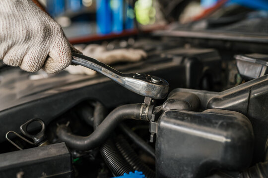Female Auto mechanic are checking and repair maintenance auto engine.