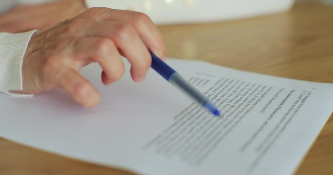 Close-up of female hand writing English test. Education and knowledge assessment concept.