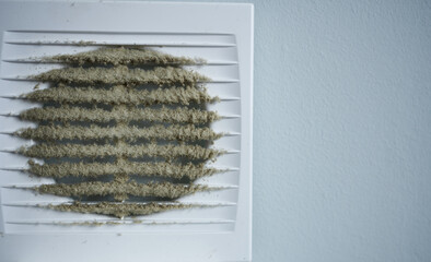 Dirty and dusty white plastic air vent. Ventilation shaft in an apartment. Dirty air filter.