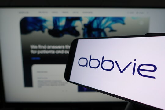 Kiel, SH, Germany March 24 2025: Smartphone displaying AbbVie logo in front of company website on a monitor emphasizes the connection between mobile technology and business