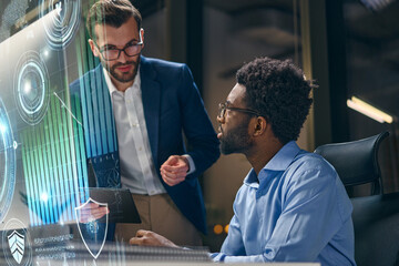 Collaborative Team Analyzing Data With Advanced Technology In Modern Office Environment