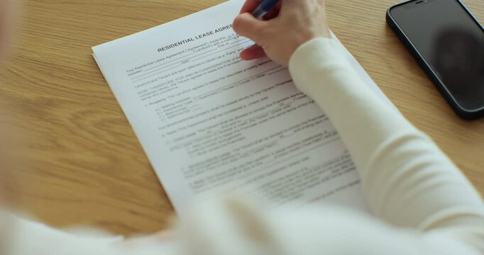 Young woman enters data in the residential rental application.