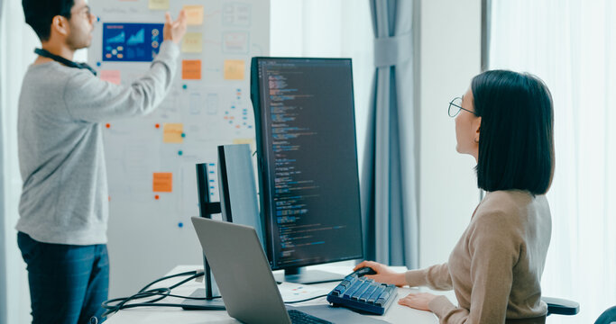 Group adult Asia male female software developers mentor leader manager talk strategy plan to executive write prompt AI bot IT app program nomad, video game, data center. Whiteboard slideshow code.