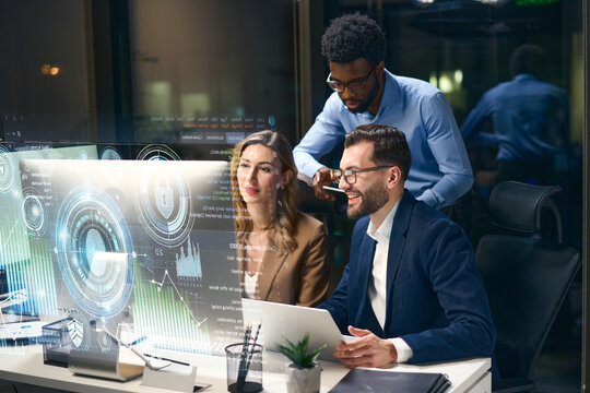 Team collaborating on futuristic technology and digital data visualization in a modern workspace.