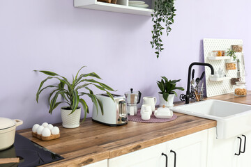 Interior of modern kitchen with sink and toaster