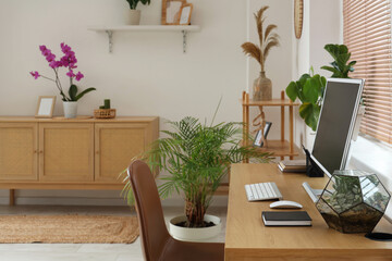 Computer monitor with florarium on table in office