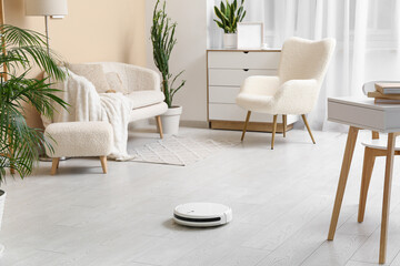 Modern robot vacuum cleaner on floor at home
