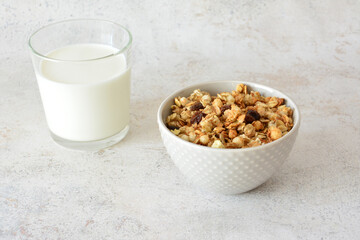 Granola cereal with milk in a glass, a healthy and delicious breakfast