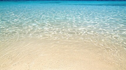 Crystal Clear Ocean Water Gently Laps Against the Sandy Shore