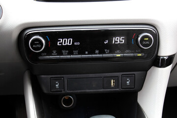Fototapeta premium New car Climate Controls. Car air conditioning control. AC Temperature Panel Board. Dual Digital Climate Control Panel. Buttons for turning on car air conditioner.