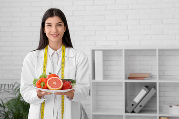 Female nutritionist with healthy food in office