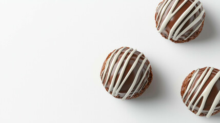 Fototapeta premium Luxurious milk chocolate pralines with white chocolate drizzle on white background for dessert inspiration