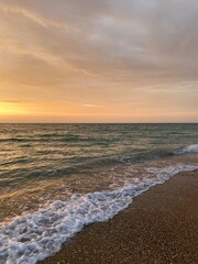 Fototapeta premium Landscape view of sunset sky and sea with waves