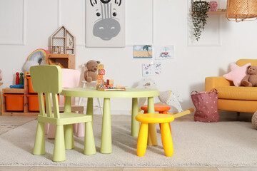 Interior of playroom with toy table and chairs in kindergarten