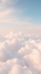 Fototapeta premium Fluffy pink and white clouds softly illuminated by sunlight against a pale blue sky, creating a serene, dreamy atmosphere. Phone background wallpaper 
