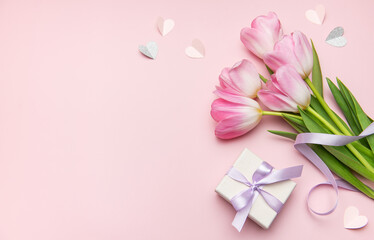 Pink tulips and gift box on pink background for mother's day or valentine's day