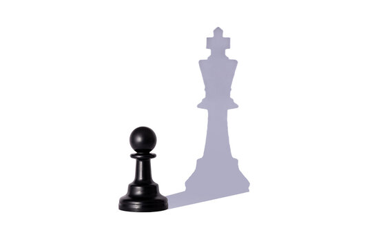 Aspiration. A picture of a pawn, but a shadow of a king chess piece. Pawn with shadow of a king isolated on white background.