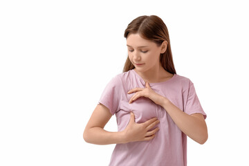 Young woman checking her breast on white background