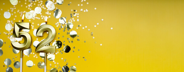 Golden candle number fifty-two on yellow background. Birthday card with lettering 52. Anniversary...