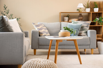 Interior of living room with grey sofas and table