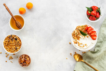 Flat lay composition with yogurt and muesli in bowl served with ingredients. Top view