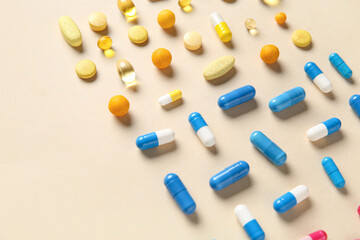 Different pills on beige background, closeup