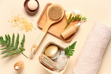 Composition with spa accessories, cosmetics and fern leaves on color background