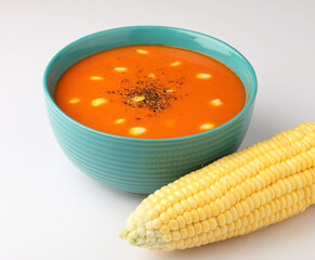 tomato soup with sweet corn on white background
