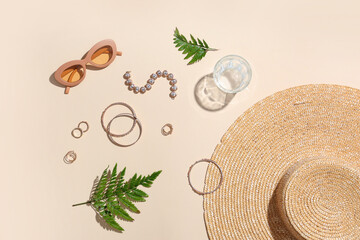 Composition with stylish female accessories, glass of water and fern leaves on color background
