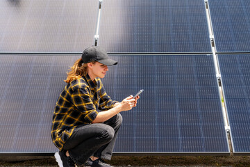 Woman monitoring PV system using her smart phone and mobile app