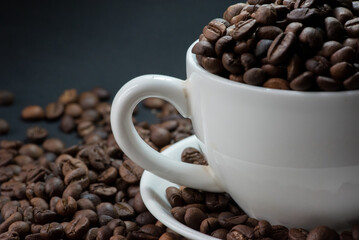 coffee in white cup and coffee beans are the background.