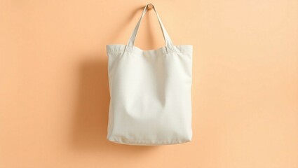 Plain canvas tote bag mockup, hanging on a natural wooden peg