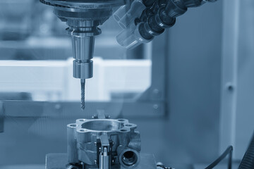 The tapping process on CNC milling machine in the light blue scene.