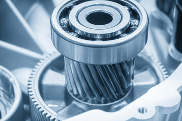 Close up scene the electric vehicle transmission gear parts in the light blue scene.